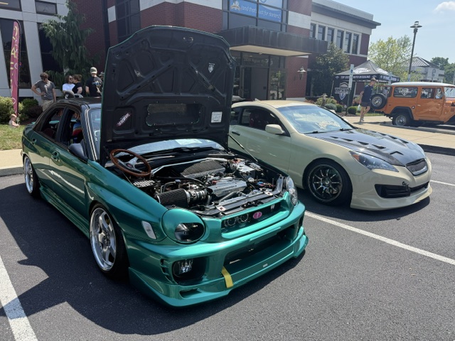 Modified Subaru and sports cars on display at Cars and Coffee in Wyomissing Pennsylvania.