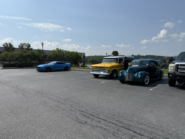 Classic truck and blue muscle car at Cars and Coffee in Wyomissing Pennsylvania.