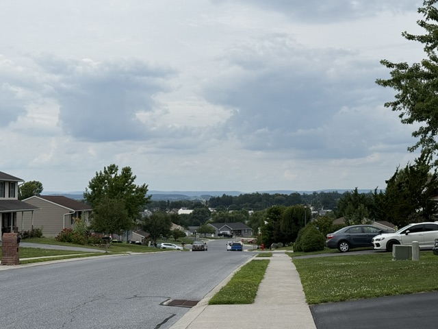 Elevated street view of Newburg Village in Newmanstown Pennsylvania with distant countryside views.