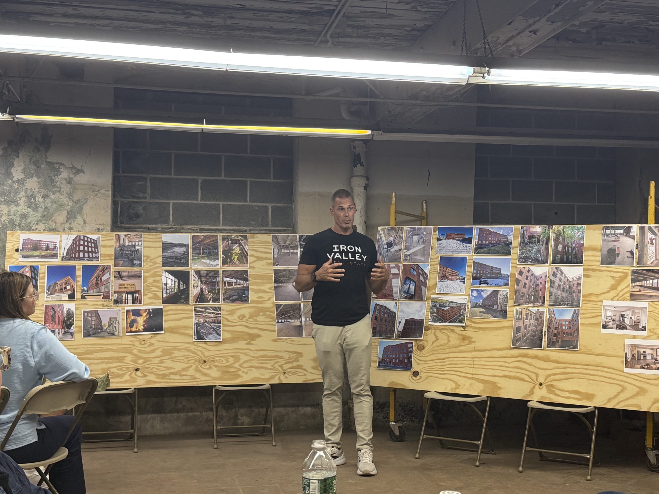 Project developer presenting photographs of the 1125 Moss Street redevelopment during an R-BAR event.